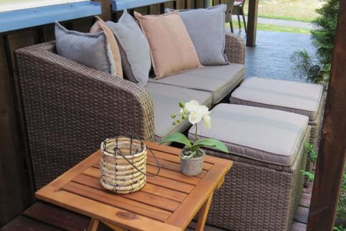 a porch with a couch and a table at Sehr schönes Ferienhaus auf eingezäunten Grundstück mit Kamin und einer Sauna in Extertal