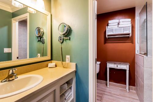a bathroom with a sink and a mirror at Cambria Pines Lodge in Cambria