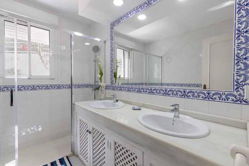 a bathroom with two sinks and a shower at Casa Villa Lumar in Almuñécar