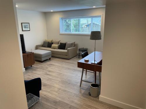 a living room with a couch and a table at Outdoor Adventure ! Large 2 bedroom private suite in North Vancouver