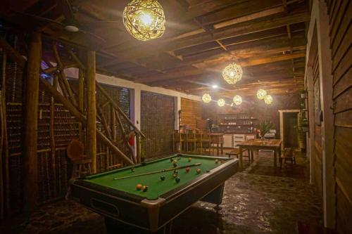 a billiard room with a pool table and lights at Casa El Valle - Private house with pool and beach in El Valle