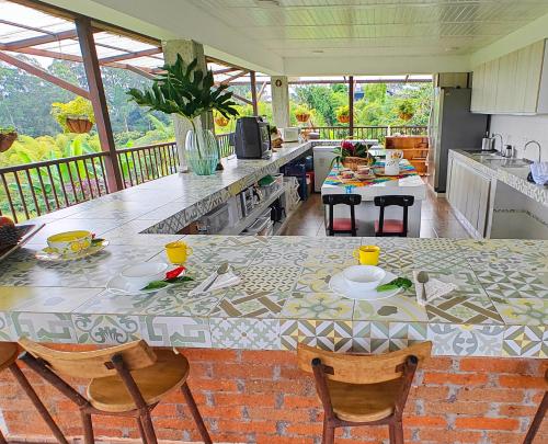 a kitchen with a table with chairs and a counter top at Zenith Bed & Breakfast in Pereira