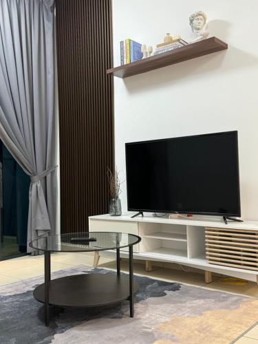 a living room with a tv and a coffee table at REIZZ RESIDENCE BY BERJAYA in Kuala Lumpur