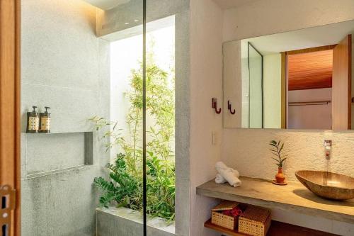 une salle de bain avec un lavabo et un miroir dans l'établissement Anaya - Villas de Luxo, à Passo de Camarajibe