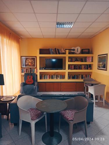 a living room with a couch and a table and chairs at Hotel Armida in Laigueglia