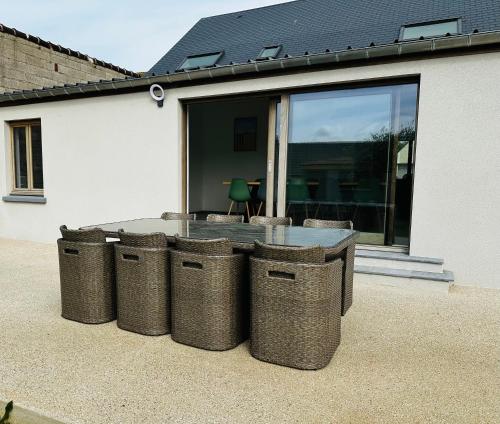 a group of three trash cans in front of a house at Cap à la mer in Sangatte