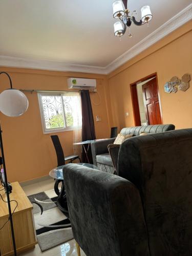 a living room with couches and a table at Lekker Estate in Yaoundé