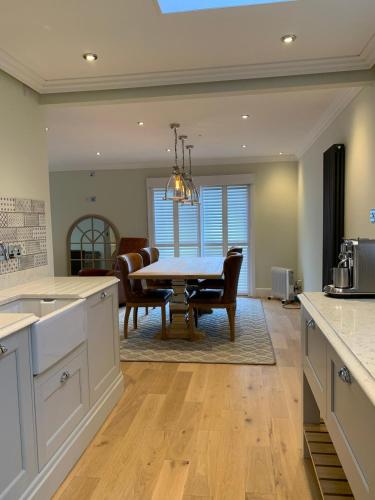 a kitchen and dining room with a table and chairs at Stormfront Luxury Hideaway Glencoe Ballachulish Highlands Near Fortwilliam in Glencoe