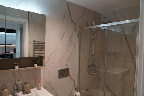a bathroom with a shower and a sink at Diamond 72 apartment , Skopje City - Center, Diamond Residences, free parking in Skopje
