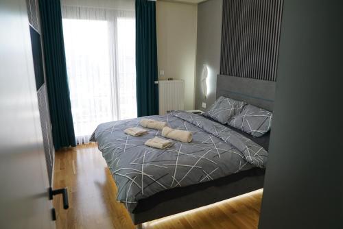 a bedroom with a bed with two towels on it at Diamond 72 apartment , Skopje City - Center, Diamond Residences, free parking in Skopje