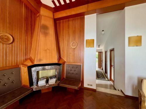 a living room with a fireplace and wooden walls at Villa Sibilla in Sirolo