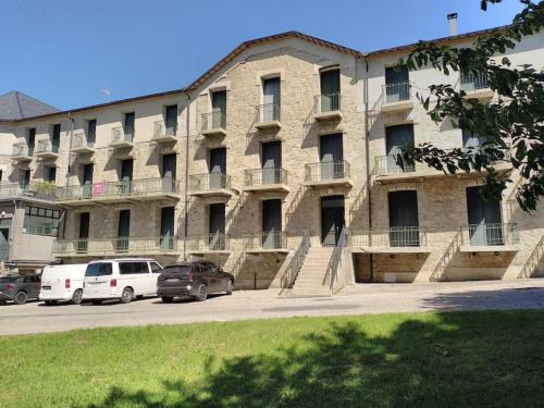 a large building with cars parked in front of it at 2 pièces 30m2 et Balcon vue montagne Villa Saint Paul WIFI Location à la semaine du samedi au samedi in Font Romeu Odeillo Via