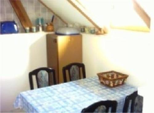 a kitchen with a table with a blue and white table cloth at Appartement in Meiersberg mit Grill, Terrasse und Garten - b48747 in Grambin