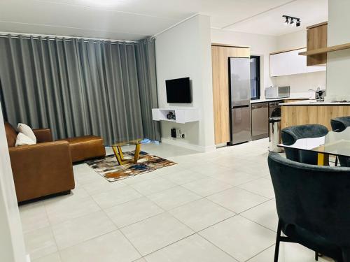 a large living room with a couch and a kitchen at Ballito Hills Lifestyle Estate in Ballito