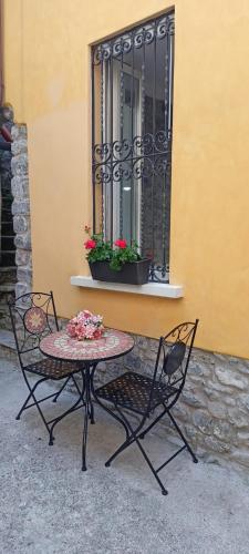 a table and chairs sitting in front of a window at Dream Holiday in Argegno
