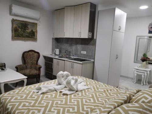 a room with a bed with an elephant on it at In Apartments AirPort in Mitrovići