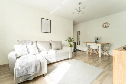 a living room with a couch and a table at Apartament Gold - 2 osobne sypialnie z balkonem - SpaceApart in Jelenia Góra