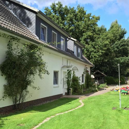 a white house with a yard in front of it at Wolterdinger Hof in Soltau