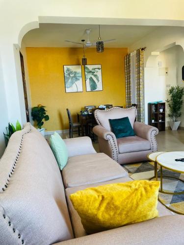 a living room with a couch and a table at Pwani 2bedroom apartment in Mombasa