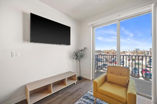 a living room with a chair and a large window at Riverside Plaza Blue in Milwaukee