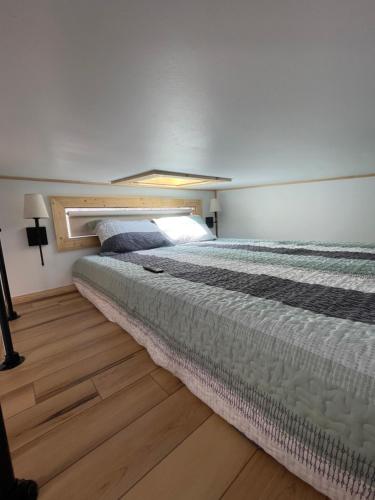 a bedroom with a large bed in a room at The Tennessee Tiny House in Sevierville