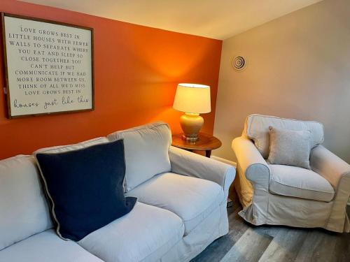 a living room with two chairs and a couch and a lamp at London Towne Bungalow Wloft - Walk To The Beach! in Edgewater