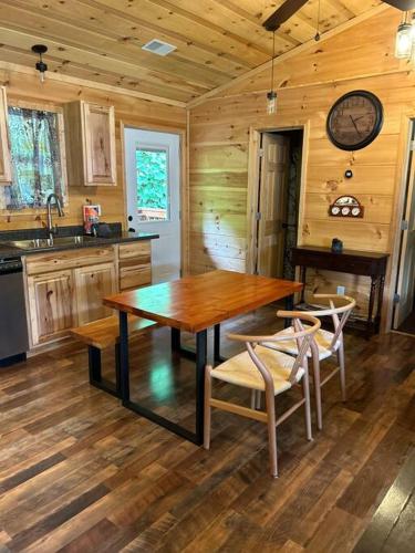 a kitchen with a wooden table and chairs at Easy Living in Gatlinburg in Gatlinburg