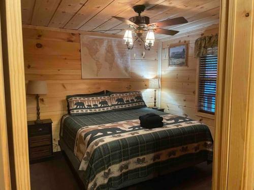 a bedroom with a bed and a ceiling fan at Easy Living in Gatlinburg in Gatlinburg