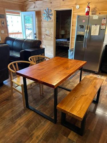 a kitchen with a wooden table and a refrigerator at Easy Living in Gatlinburg in Gatlinburg