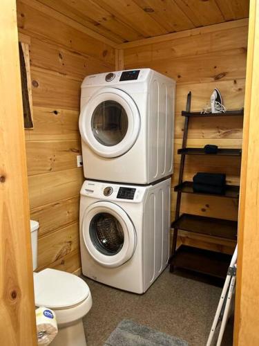 a bathroom with a washing machine and a toilet at Easy Living in Gatlinburg in Gatlinburg