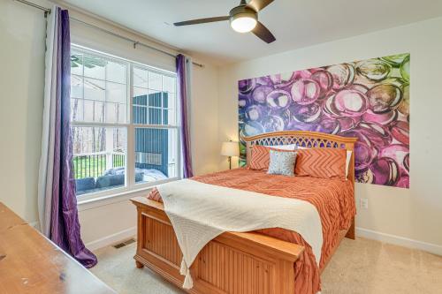 a bedroom with a painting on the wall at Lakefront Fredericksburg Home with Deck and Fire Pits! in Fredericksburg