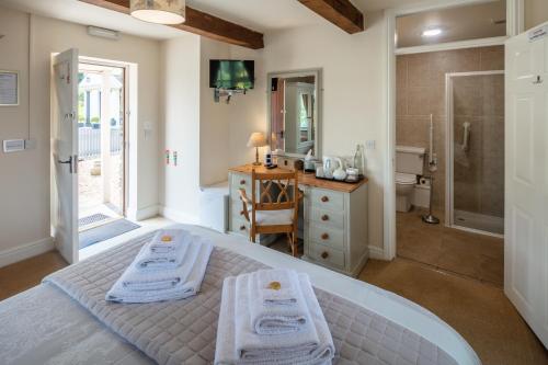 a bedroom with a bed and a bathroom with a shower at East Hook Farmhouse in Haverfordwest