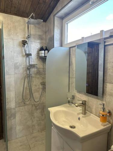 a bathroom with a sink and a shower at Swiss House Dilijan in Dilijan