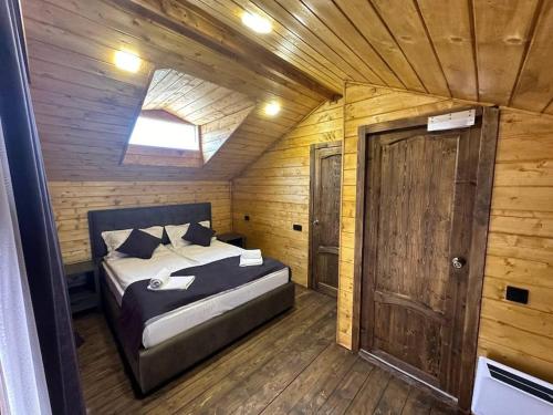 a bedroom with a bed in a wooden cabin at Swiss House Dilijan in Dilijan