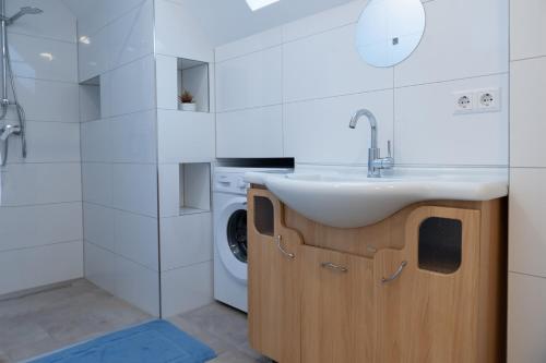 y baño con lavabo y lavadora. en Monteuerunterkunft - Flexibel und Modern!- NEU en Laichingen