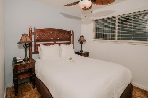 a bedroom with a large bed and a window at Pantai Inn in San Diego