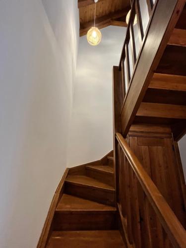 a wooden staircase in a house with a light fixture at Luxury House Valencia D'Aneu in Valencia de Aneu