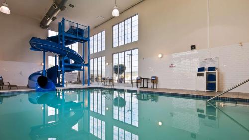 a swimming pool with a water slide in a building at Best Western Cranbrook Hotel in Cranbrook