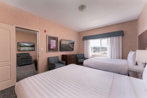 a hotel room with two beds and a window at Best Western Cranbrook Hotel in Cranbrook