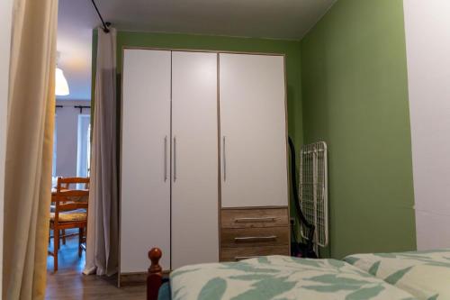 a bedroom with a white cabinet and a bed at Ferienwohnung mit zwei Schlafzimmern und Balkon - b56485 in Weißenstadt