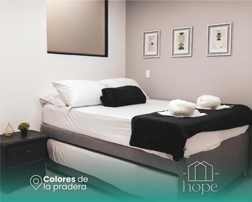 a bedroom with two beds with white sheets at Colores de la pradera by Hope in Guatapé