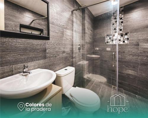 a bathroom with a toilet and a sink and a shower at Colores de la pradera by Hope in Guatapé