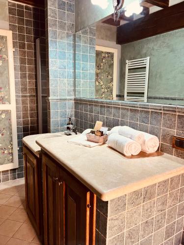 a bathroom counter with a sink and a mirror at Montepulciano For You in Montepulciano