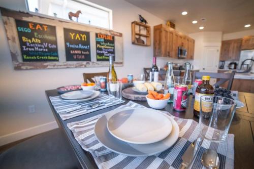 a kitchen with a table with plates on it at Red Canyon Bunkhouse at Kanab - New West Properties in Kanab