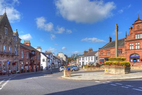 a street in a town with buildings and a car parked at School View in Melrose