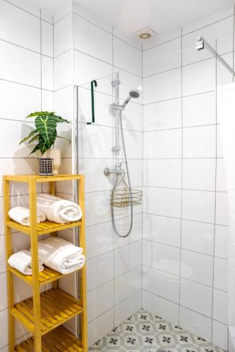 a bathroom with a shower with white tiles at Quinta da Liberdade in Luz