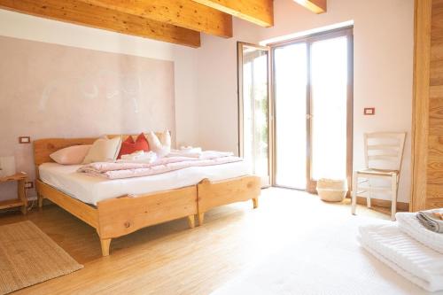 a bedroom with a bed and a large window at Le Ali del Falco in Cuceglio