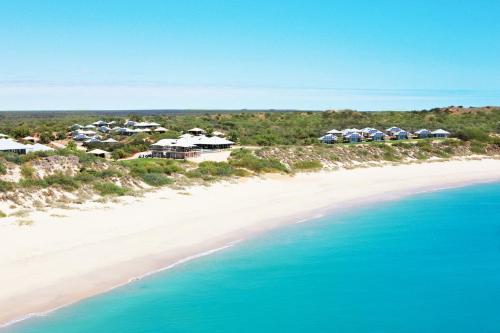 an aerial view of a beach with houses and the ocean at Eco Beach Wilderness Retreat in Broome
