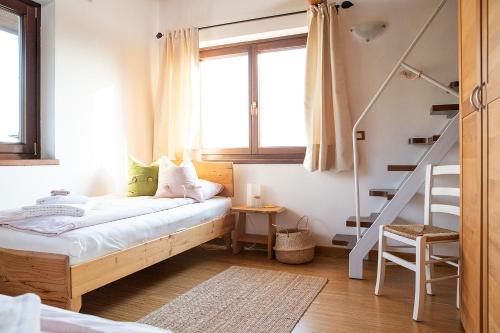 a small bedroom with a bed and a staircase at Le Ali del Falco in Cuceglio