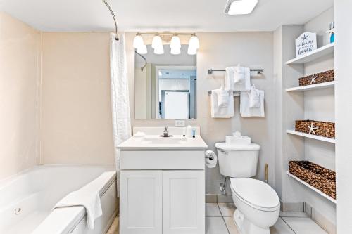 a white bathroom with a sink and a toilet at Bay Watch Resort in Myrtle Beach